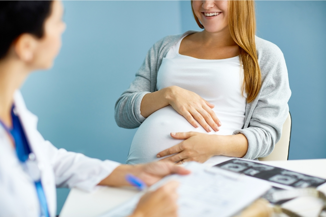 Pregnant woman at prenatal appointment with doctor